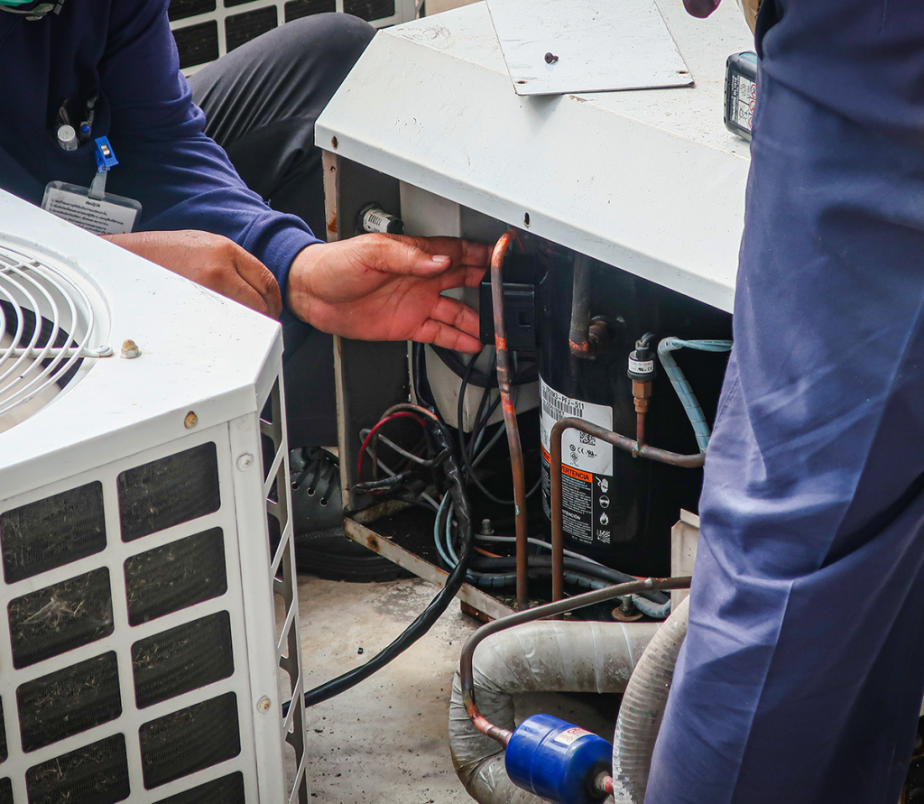 AC technicians troubleshooting a HVAC problem